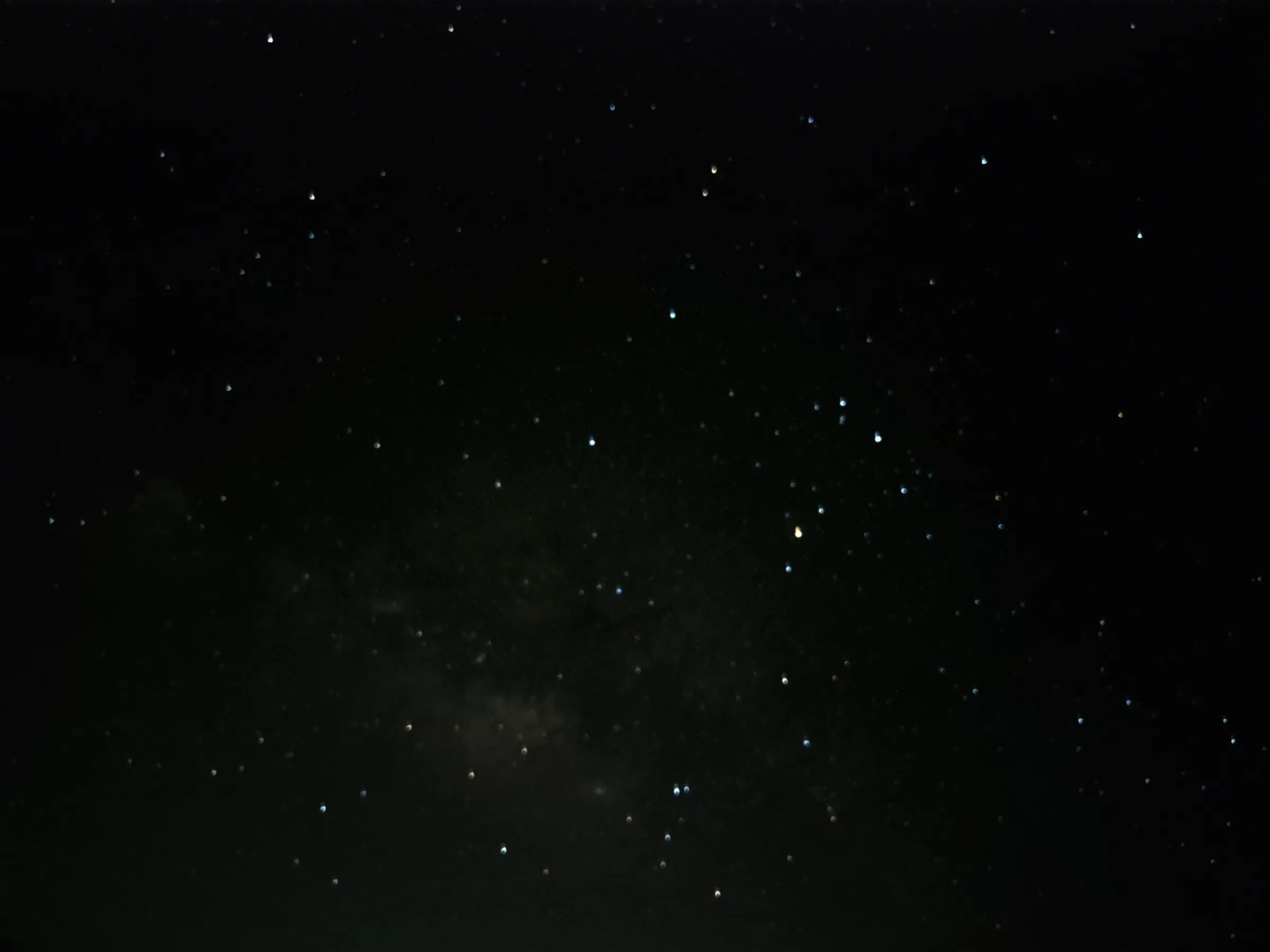A dark night sky filled with countless stars of varying brightness. A faint, diffuse glow of the Milky Way is visible. Taken from a Samsung S23 FE phone.